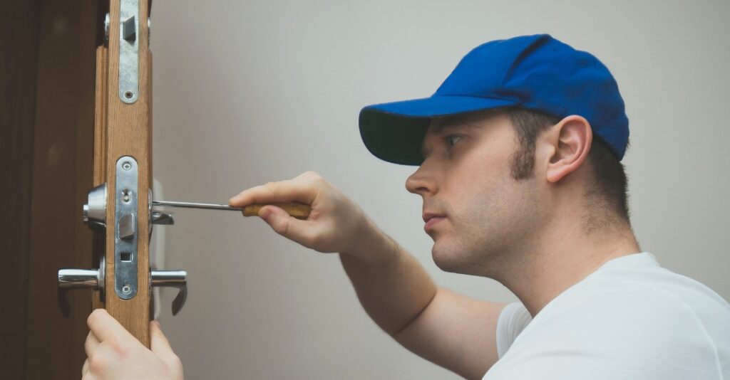 The locksmith is carefully repairing the door lock, ensuring smooth and secure operation.